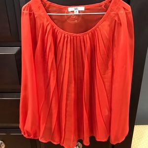 Orange flowy sheer top with pleats